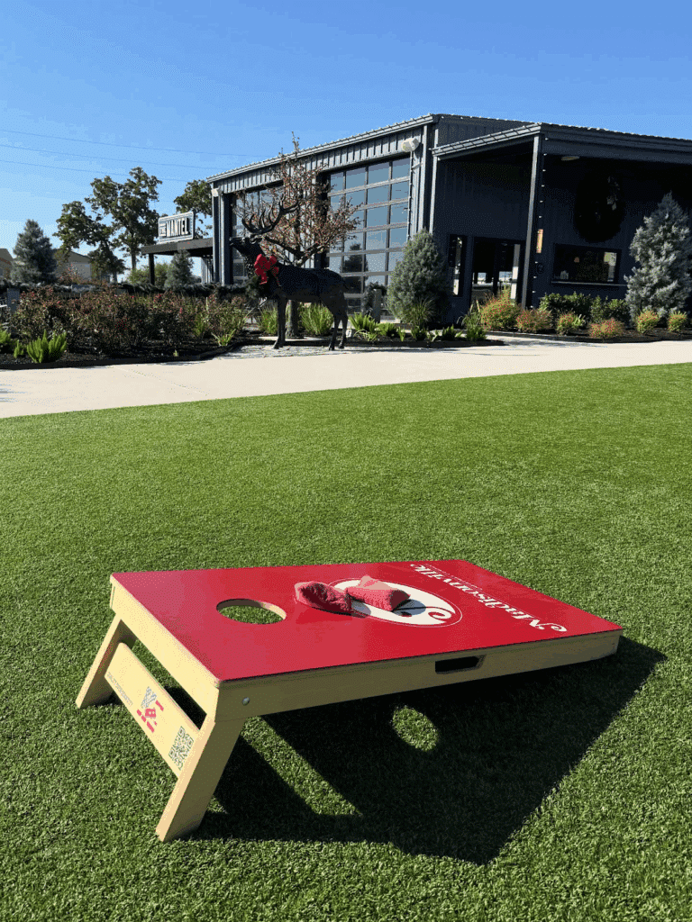 Large lawn with corn hole at Yuletide RV Park in Madisonville, TX.